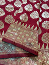 Red fabric with gold floral patterns on a red background