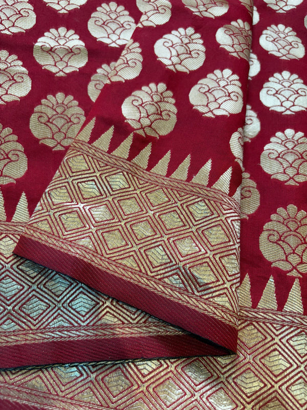 Red fabric with gold floral patterns on a red background