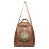 Brown leather backpack with decorative emblem on a white background