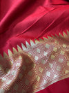 Close-up of a red fabric with gold geometric pattern