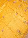 Yellow fabric with floral embroidery on a beige background