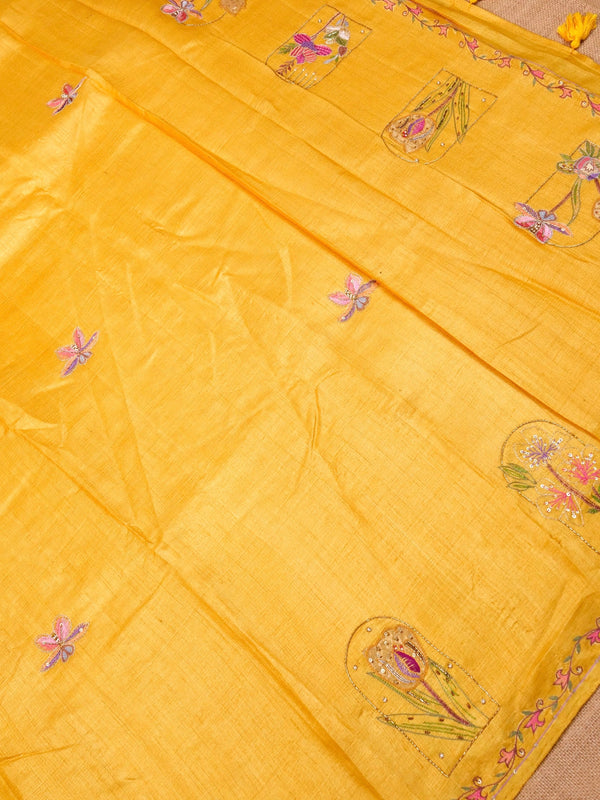Yellow fabric with floral embroidery on a beige background