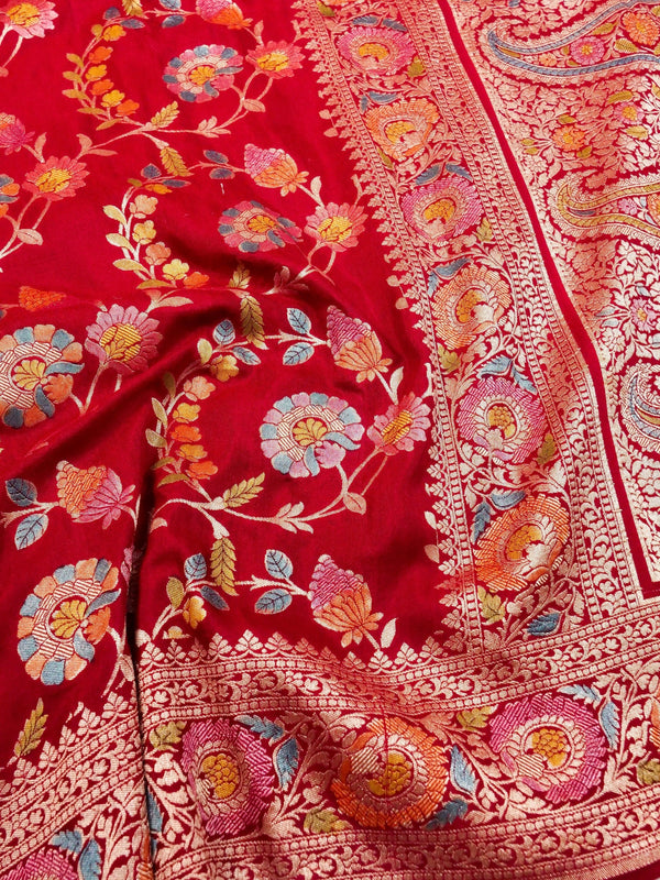 Red fabric with intricate floral embroidery and patterns