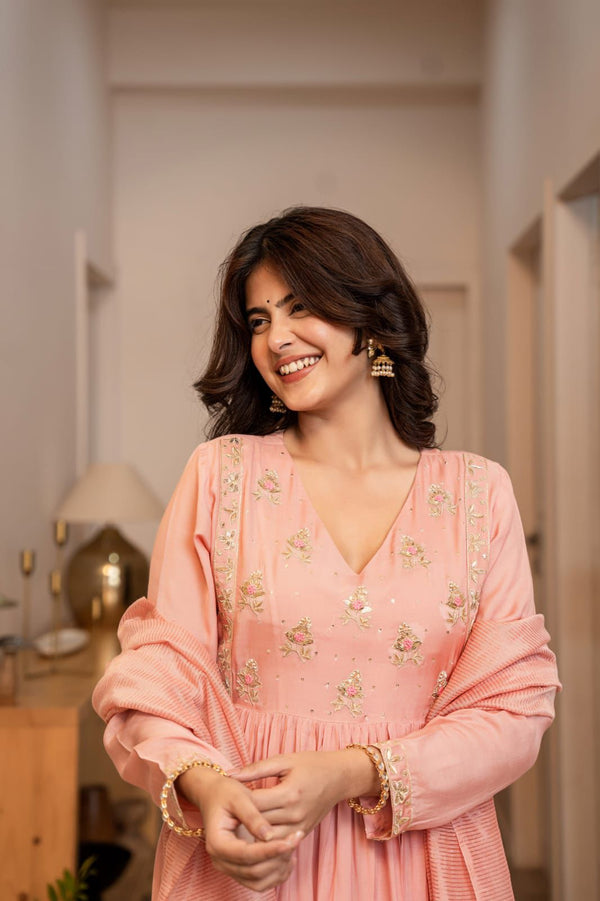 Woman wearing a pink dress with floral embroidery indoors gysy