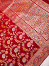 Close-up of a red fabric with intricate paisley and floral patterns