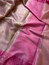 Close-up of pink and gold fabric with intricate patterns