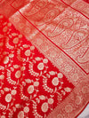 Red fabric with intricate white floral and paisley patterns