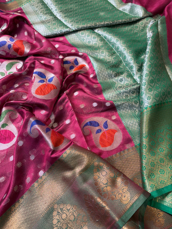 Close-up of a pink and green saree with floral patterns
