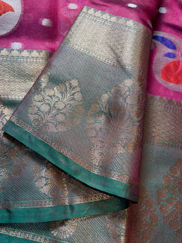 Saree with floral patterns in green and pink on a textured fabric background