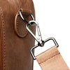 Close-up of a brown leather bag with a metal clasp and beige strap on a white background