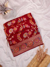 Red embroidered fabric on a white surface with decorative elements.
