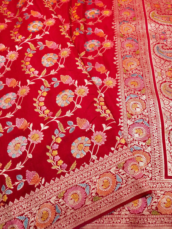 Red fabric with intricate floral patterns and embroidery