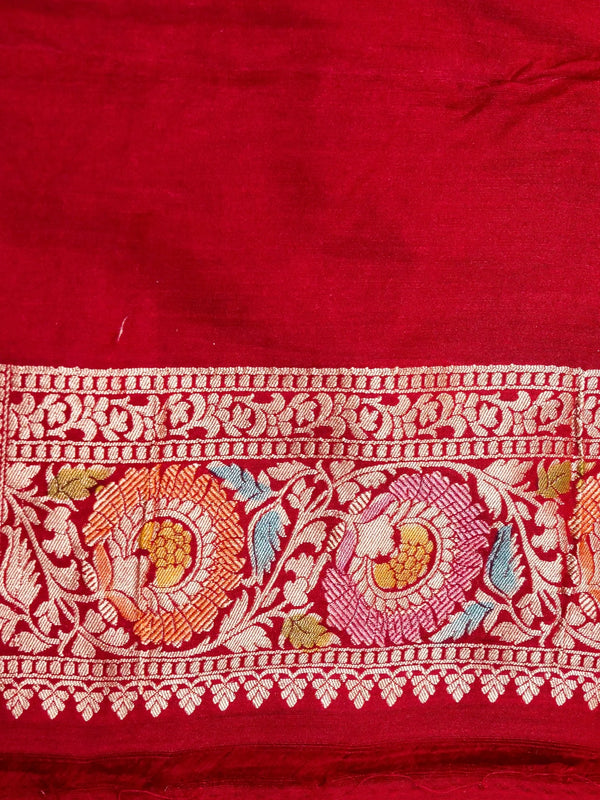 Red fabric with intricate white embroidery featuring floral and bird patterns.