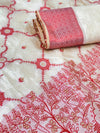 White fabric with red and gold intricate patterns, rolled up