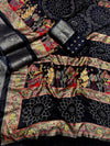 Decorative fabric with intricate patterns and embroidery on a black background