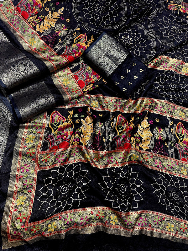 Decorative fabric with intricate patterns and embroidery on a black background