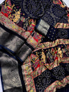 Embroidered fabric with intricate patterns and colors on a dark background