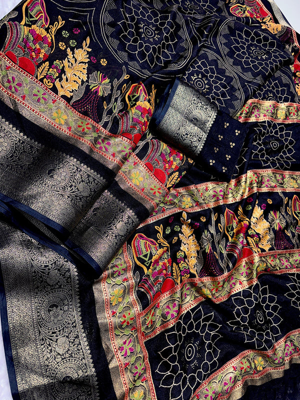 Embroidered fabric with intricate patterns and colors on a dark background