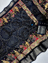 Decorative fabric with intricate patterns and embroidery on a dark background