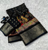 Black saree with colorful patterns on a textured white background