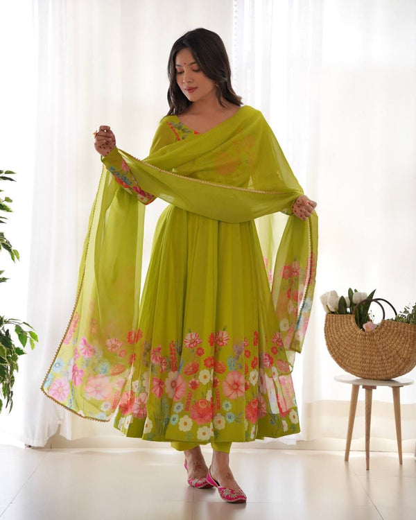 Woman wearing a bright green floral dress with a matching dupatta in a bright room.
