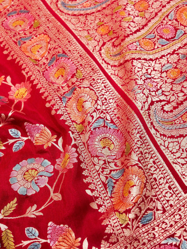 Close-up of a red fabric with intricate floral embroidery